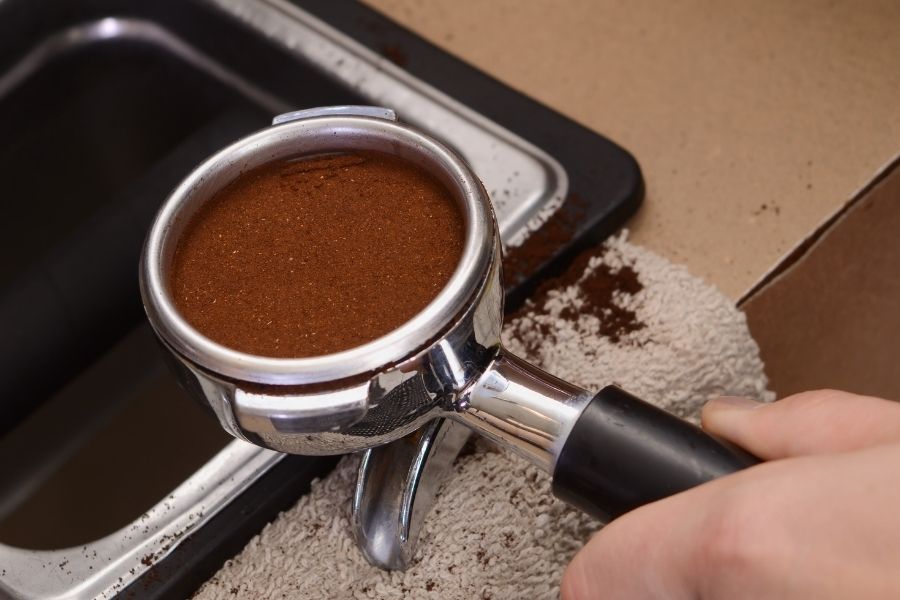 Inspecting and cleaning tamped espresso